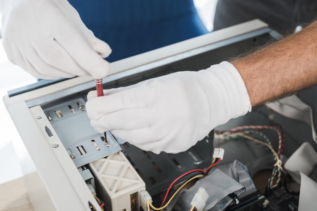 close-up-male-technician-hand-wearing-gloves-repairing-computer-min